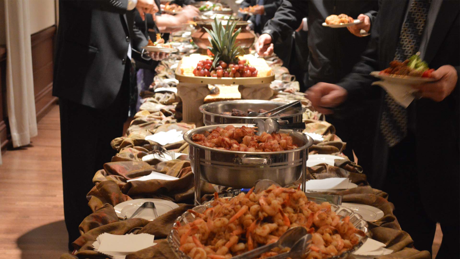 Buffet table with shrimp, fruits and other foods